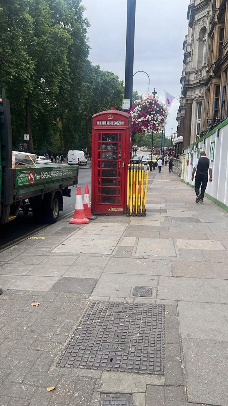 A red telephone box on a London street